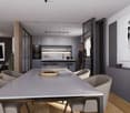 The image shows an open concept living space with a modern kitchen, dining area, and living room. The kitchen features sleek gray cabinets, a marble backsplash, and built-in appliances including a dishwasher. The dining table is a large rectangular gray t