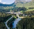 mountains, river, road, village, trees, and houses