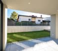 modern house, white exterior, large windows, concrete terrace, fenced garden, green grass