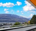 Balcony with view of city and mountains