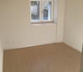 empty room, white walls, wooden floor, window, power outlets