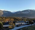 Mountain landscape, white house, black roofs, driveway, stone, trees, grass, mountains, snow
