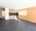 modern kitchen, black tiled floor, wooden wall, kitchen counter, windows, power outlets