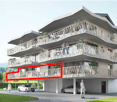 5 story building, multiple balconies, 2 car garage, cars parked on the road