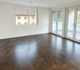 empty room with large balcony, tiled floor, sliding doors, large window