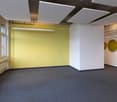 empty room, yellow wall, white ceiling, gray floor, windows, radiator, hanging lamps