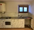 Marble countertop, white oven, marble backsplash, stainless steel sink, gas stove