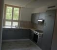 kitchen with cabinets, countertop, sink, stove, refrigerator, window