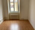 wooden floor, large window, white walls, radiator under window