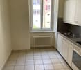 Kitchen: tiled floor, window, radiator, sink, faucet, built-in kitchen cabinets, oven, gas stove