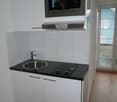 Small kitchen with a sink, microwave, dishwasher, and stove