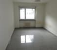empty room, tile floor, radiator, large window, bright light