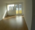 wooden floor, white walls, sliding doors, window with safety bars, sun shining in