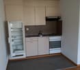 countertop, sink, refrigerator, oven, dishwasher, cabinets, tiled wall, electrical outlets