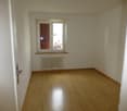 empty room, wooden floor, white walls, window with blinds, white radiator