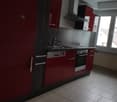 modern kitchen, red cupboards, white tiles, gas stove, sink, dishwasher, washing machine, double window