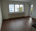empty room, large window, balcony, wooden floor, white walls, white radiator