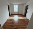 empty room, wooden floor, two doors, one window