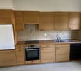 modern kitchen with tile backsplash, stainless steel sink, wooden cabinets, integrated dishwasher, refrigerator, and gas stove