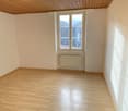 empty room, wooden floor, white walls, window, radiator