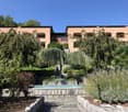 Swimming pool, stone pathway, trees, plants, bushes, fountain