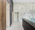 Tiled floor, marble countertop, wooden door, abstract mural