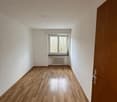 empty room, hardwood floors, white walls, single window, closed wooden door