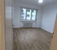 wood floor, radiator, large window with outside view