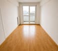 empty room, wooden floors, glass doors leading to balcony, white walls, built-in heater