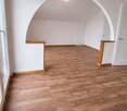 empty room, wooden floor, white walls, arched ceiling, two doors, large window