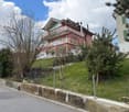 2 story house, red brick, white windows, balcony, garden, fence