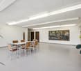 empty room, white walls, white ceiling, white table and chairs, painting on the wall, plants