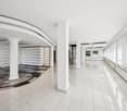 white tiled floor, white walls, white ceiling, white pillars, white windows, spiral staircase