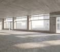 Empty room with concrete walls, large windows, and a concrete floor.