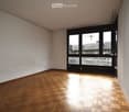 empty room with parquet floor, large windows, city view
