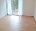 empty room, wooden floors, sliding glass doors to balcony, white walls