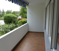 Empty balcony with awning, red floor tiles, closed window