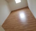 Empty room with wooden floor and white walls