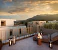 Modern house with a balcony, terrace, and a view of the mountains