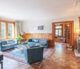 fireplace, blue sofa, carpet, wooden floor, windows, lamp