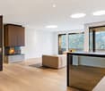 modern fireplace, beige couch, dining table, wooden floor, sliding doors, sliding balcony doors, mountain view