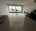 empty room, large sliding glass doors, balcony, concrete floor, white walls