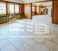 empty room, wooden walls, white tiled floor, large windows, radiators