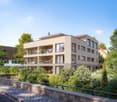4 story building, beige exterior, multiple balconies, garden, trees