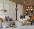 Modern living room with gray couch, circular tables, chandelier, and wood floors.