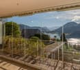 large sliding glass wall, balcony, wooden floor, lake view, mountain view