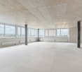 empty room, tiled flooring, large windows, white walls, several pillars