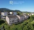 Row houses, concrete facade, multiple floors, multiple windows, balcony