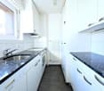 modern kitchen with granite countertops, stainless steel sink, dishwasher, electric hob, oven, cabinets, power outlets, white tiles