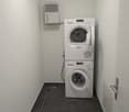 room with washing machine and dryer, air purifier on the wall